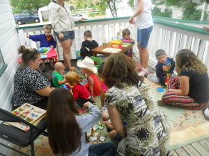 A group of children and adults outdoors.