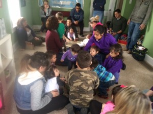 A group of children and adults indoors.